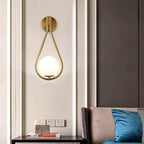 DARBE Nordic Brass Wall Light with frosted globe mounted on living room wall.