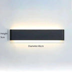 Wall Light LYST minimalist dark grey aluminium LED wall light with up and down lighting mounted on bedroom wall