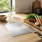 Premium Stainless Steel Chopping Board – double-sided, knife-safe, anti-bacterial; Nordic Essentials on kitchen counter.