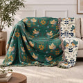 100% Cotton Reversible Throw Blanket with bird pattern; teal side on sofa, white floral reverse visible.