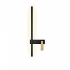 SVEA Swivel LED Wall Light black with brass accent, mounted on a bedroom wall for reading.