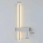 SVEA Swivel LED Wall Light, modern Nordic reading lamp for bedroom; white finish with warm LED glow beside bed.