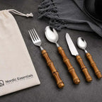 24-Piece Bamboo Handle Cutlery Set Stainless Steel Flatware: 4 bamboo-handle utensils on a dark surface with Nordic Essentials bag.