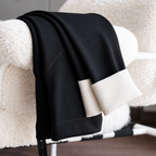 Black maternity thick fleece leggings with belly support panel draped over a chair