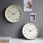 Nordic Wooden Wall Clock - Minimalist Silent Timepiece, cream-faced clock with wooden frame; two clocks on a grey wall.
