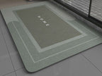 Green super absorbent bath mat with 'HOME' text on a bathroom floor