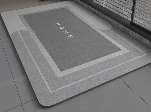 Gray bath mat with 'HOME' text on a bathroom floor